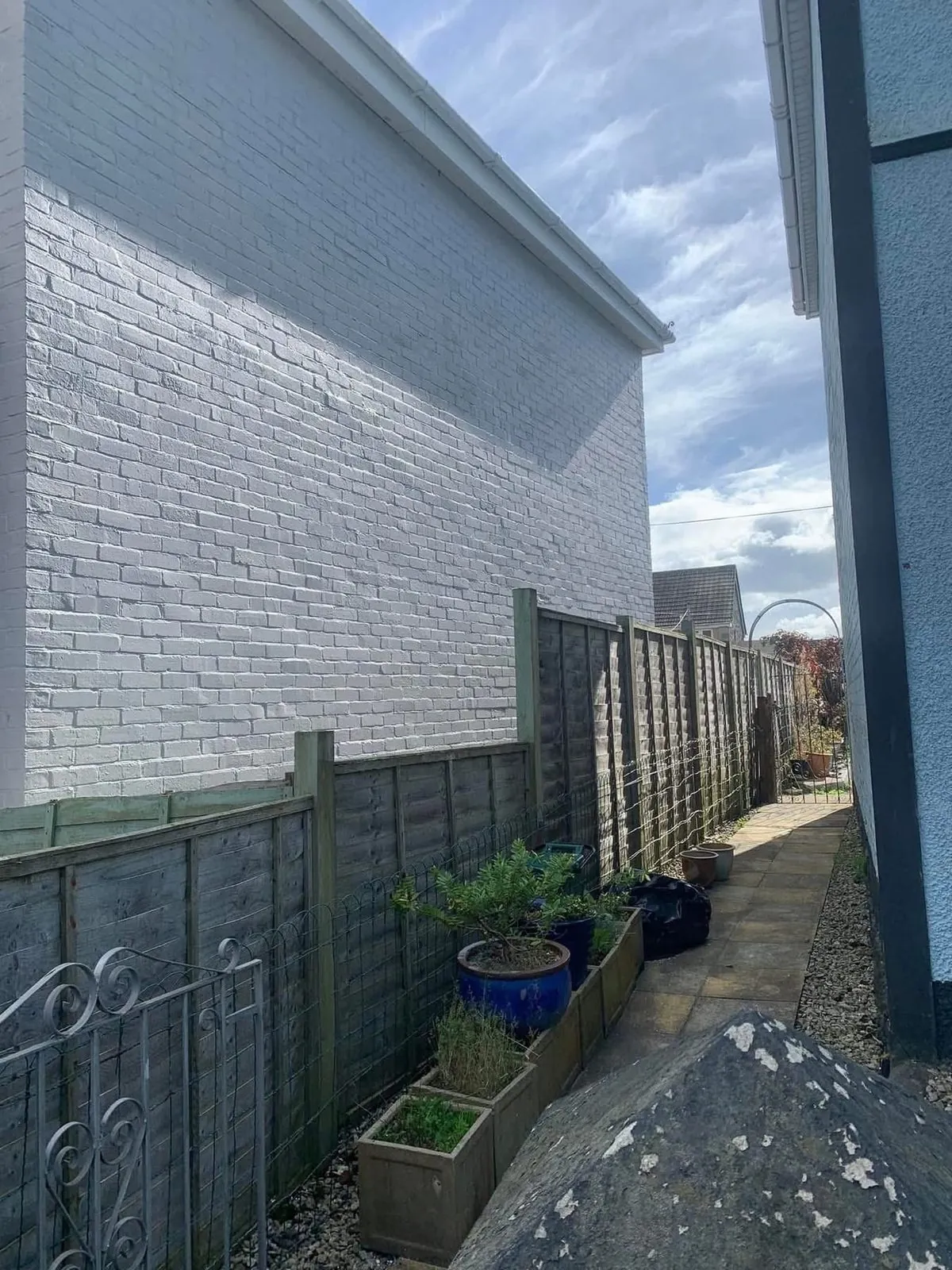 Freshly painted brick wall after preparation and masonry paint in Helston