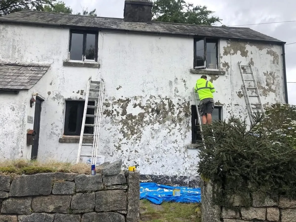 Cottage with blown, flaking render before repair in Helston